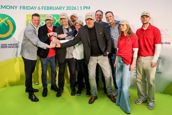 POMPUR employees hold up their award for the camera at the FLIA ceremony. 