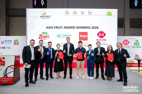 Many people staying on stage with a banner behind them that says "ASIA FRUIT AWARD WINNERS 2026"
