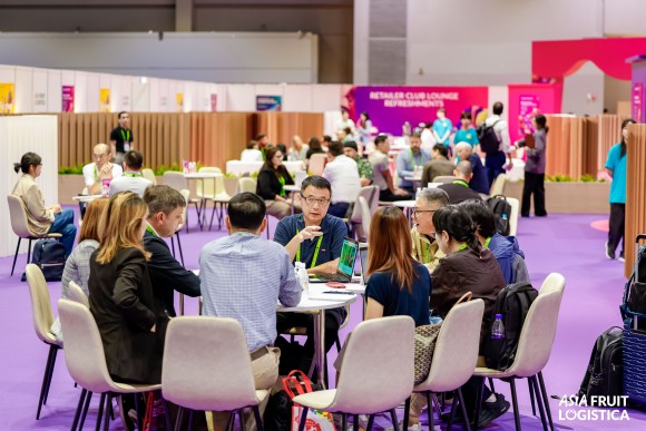 A group of people sits around a table and talks.