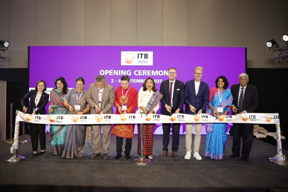 ten persons in front of an ITB India backdrop, smiling into the camera and cutting the official ribbon of ITB India.