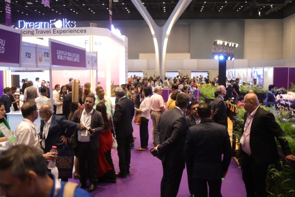 Visitors and exhibitors gather at a vibrant booth during ITB India 2025, showcasing dynamic networking and industry engagement.